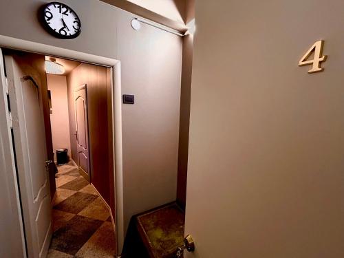 a hallway with a clock on the wall at Traditional Narva House in Narva