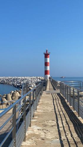 a lighthouse on a pier next to the water at Les mobil homes de Naka, 6 places, TV, CLIM in Port-la-Nouvelle