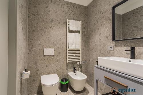 a bathroom with a sink and a toilet and a mirror at Palazzo Piccinni 97 by Apulia Accommodation in Bari