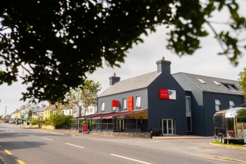 a blue building on the side of a street at Cliffs of Moher Hotel in Liscannor