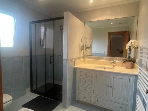 a bathroom with a shower and a sink at Cerca de Santander La Llosa de Muriedas en Urbanización in Camargo