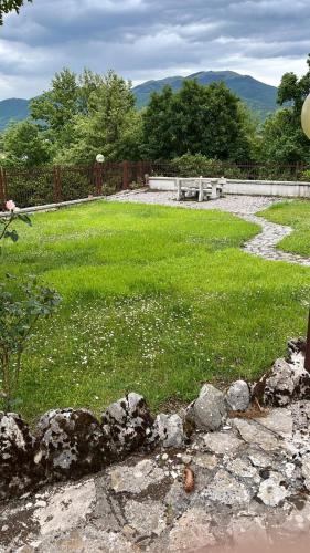 a field of grass with a bench in the background at Casa Belvedere Leonessa in Leonessa
