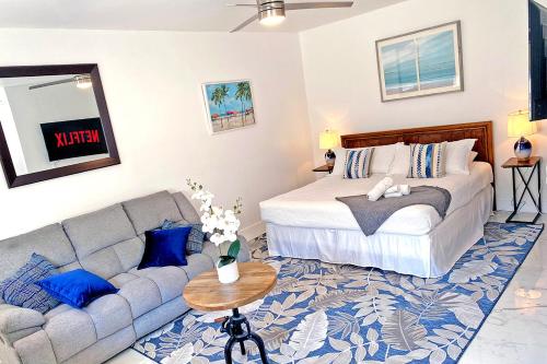 a living room with a bed and a couch at Family Favorite- Heated Pool, 2 Kings, Everglades in Homestead