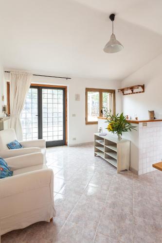 a living room with a couch and a table at Casetta nel bosco di Valeria e Davide in Rocca Priora