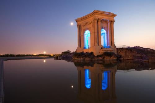 a building in the middle of a body of water at Hotel d'Aragon - Place de la Comédie in Montpellier