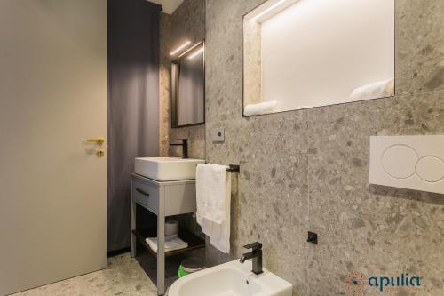 a bathroom with a sink and a mirror at Palazzo Piccinni 97 by Apulia Accommodation in Bari