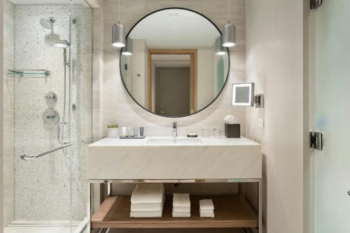 a bathroom with a sink and a mirror at JW Marriott Tampa Water Street in Tampa