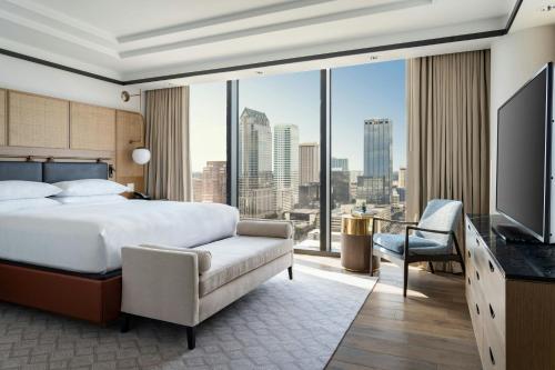 a hotel room with a bed and a large window at JW Marriott Tampa Water Street in Tampa