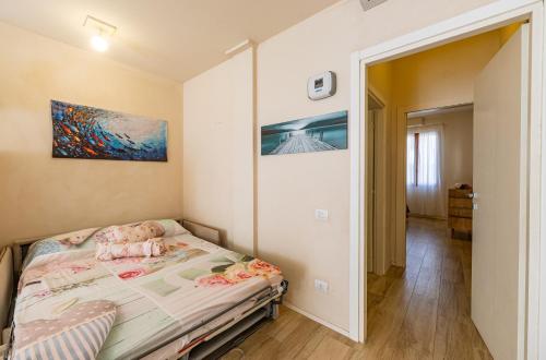 a bedroom with a bed and a painting on the wall at Designer Apartment in Porto Azzurro in Porto Azzurro