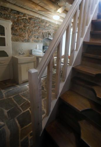 a staircase leading up to a kitchen with a sink at Stone houses Areti 2 in Manganítis