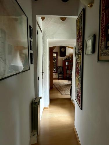 a hallway leading to a living room with at Casa Añeja in Collbató