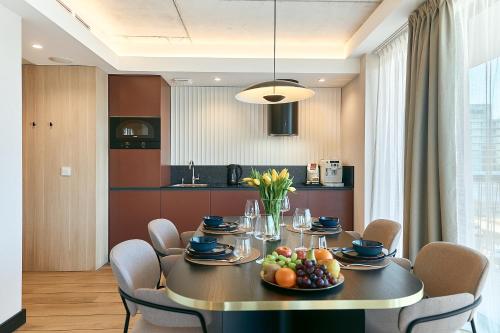 a dining room with a table with fruit on it at Golden Hour Apartments- Loft H 302 in Świnoujście