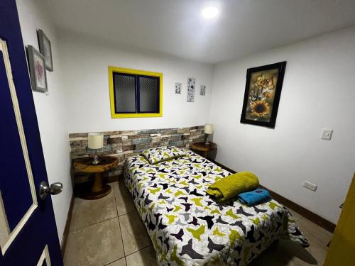 a bedroom with a bed in a room at Apartahotel Casa Azul Salento in Salento