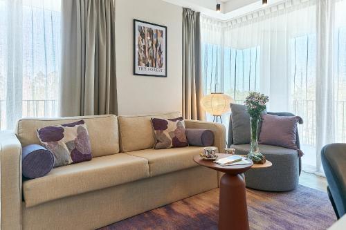 a living room with a couch and a table at Golden Hour Apartments- Loft H 302 in Świnoujście