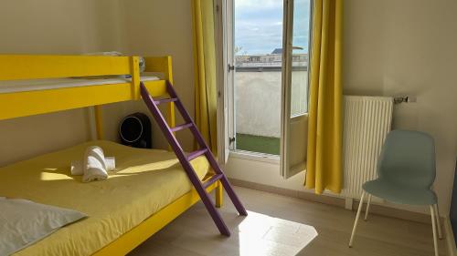 a bunk bed with a ladder in a room with a window at VERY CENTRAL DISNEYLAND apartment in Serris