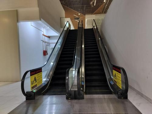 an escalator in a building with a staircase at The Luxe Colony Klcc By NTR Resources in Kuala Lumpur