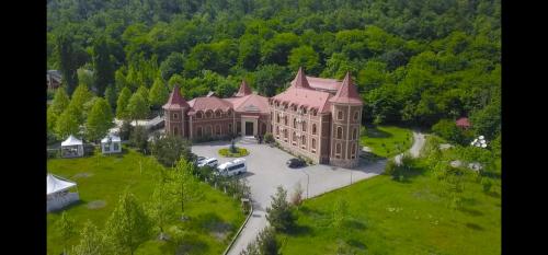 an aerial view of a large building with a yard at Chateau Qusar Hotel & Restaurant in Qusar