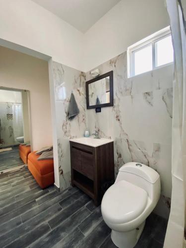 a bathroom with a toilet and a sink at Departamento Arrecife in La Paz