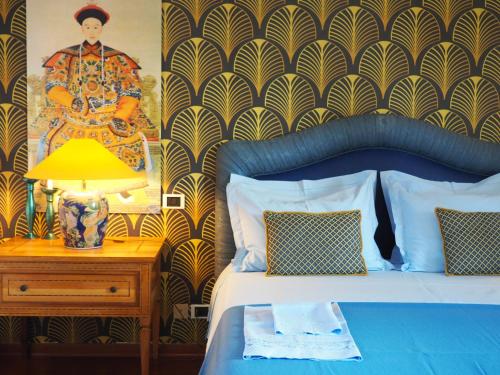 a bedroom with a bed with a lamp on a night stand at Aura Relais in Numana