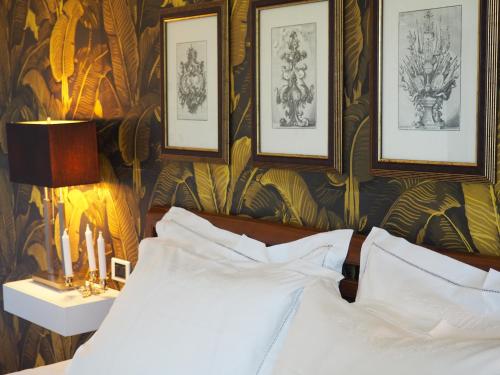 a bedroom with a bed and pictures on the wall at Aura Relais in Numana