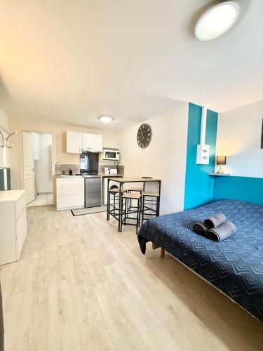 - une chambre et une cuisine avec un lit et une table dans l'établissement Studio confort - Portet-sur-Garonne, à Portet-sur-Garonne