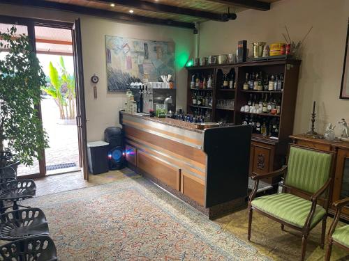 a bar with a counter and chairs in a room at Fattoria Raffaelli in Colle Farnese