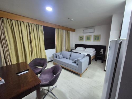 a hotel room with a bed and a table and chairs at M-Flat Hotel Diamond - Vila Olimpia in Sao Paulo