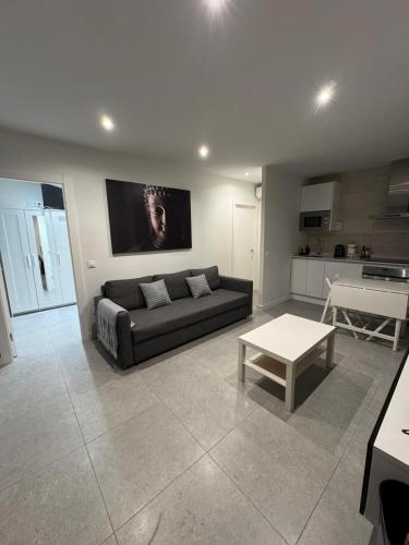 a living room with a couch and a table at Apartamentos EL SERRÓN Colombres in Colombres