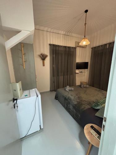a bedroom with a bed and a desk with a computer at Rooms the other side of the island by Patitiri in Saterlí