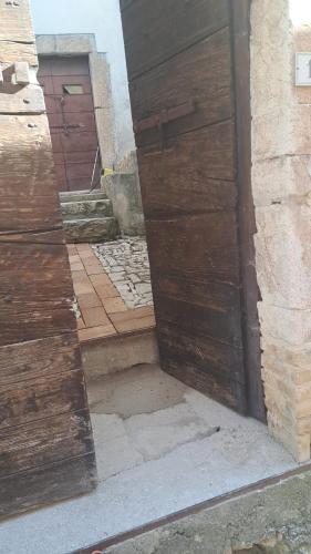 a pair of wooden doors on the side of a building at B&B Il Rifugio della Felicità Civitella in Setri
