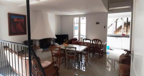 a dining room and living room with a table and chairs at Crew Lighthouse in Antibes