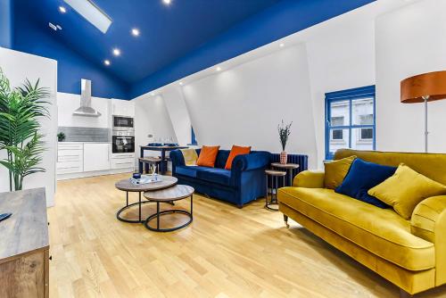 a living room with a yellow couch and a table at Bright and Spacious 2 bed apartments in Central London in London