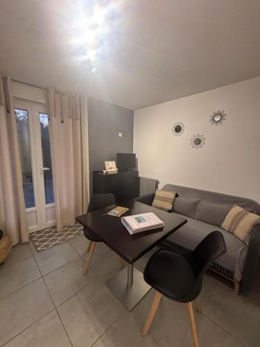 a living room with a couch and a table at Appartement en aveyron in Aubin