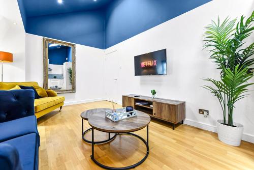 a living room with a couch and a table at Bright and Spacious 2 bed apartments in Central London in London