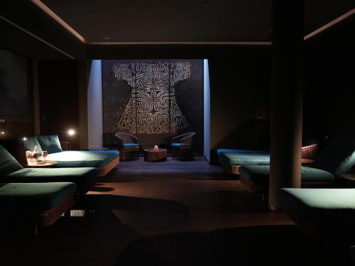 a dark room with couches and a painting on the wall at WANDERLUST HOTEL - SUITE & SPA - APARTMENTS & VILLAS - Bardolino, Lago di Garda - Verona in Bardolino