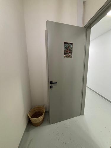 a white door in a room with a basket at Rooms the other side of the island by Patitiri in Saterlí