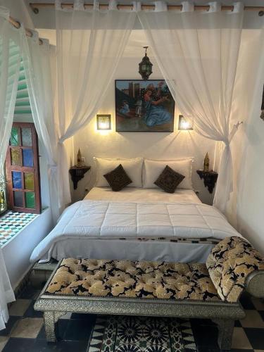 ein Schlafzimmer mit einem weißen Bett mit Baldachin in der Unterkunft Room 1 Riad Khadija in Rabat