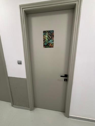 a white door with a picture on it at Rooms the other side of the island by Patitiri in Saterlí