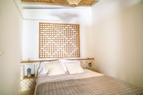 a bedroom with a bed with a brick wall above it at casita antiguo lavadero in Collado-Villalba