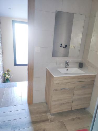 a bathroom with a sink and a mirror at Casa Souto in Santa Comba