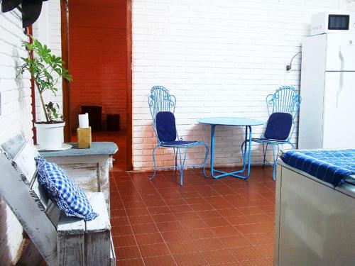two blue chairs and a table on a patio at Astonishing house by the beach CASA AZUL in Playa Verde