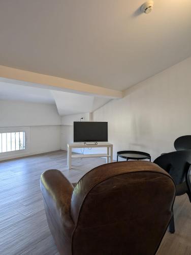 a living room with a couch and a tv at Hotel Alabama by ALEhotels in Rimini