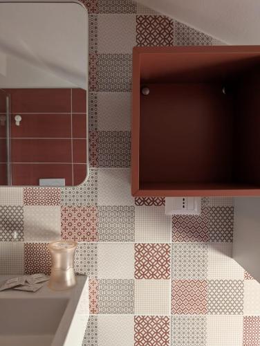 a bathroom with a sink and a mirror at Hotel Alabama by ALEhotels in Rimini