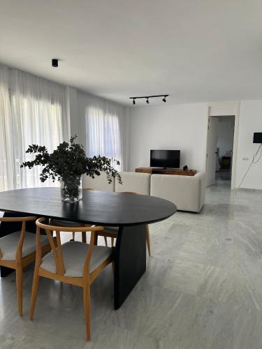 a living room with a table and chairs and a couch at Sol Puerto Apartamento en Almerimar in Almerimar