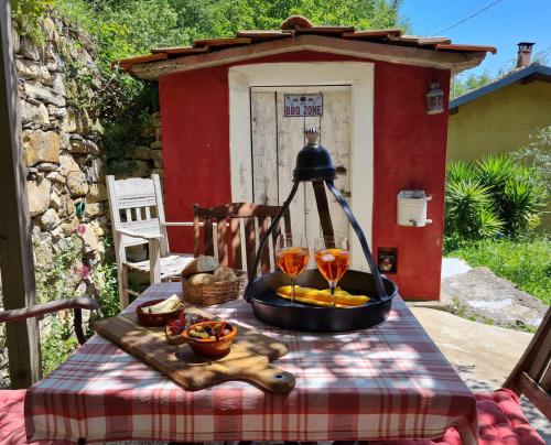 a table with a bowl of food and two wine glasses at Bella Casa Cantoniera in Caravonica