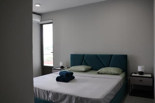 a bed with a blue stuffed animal sitting on it at Ocean Bliss Penthouse - Private Pool & 2 Min to Beach in Flic-en-Flac