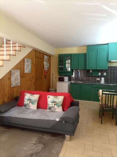 a living room with green cabinets and a couch at Casa à Porta do Torreão in Silves