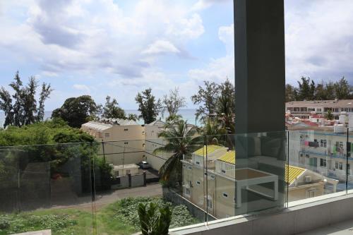 a view of a city from a balcony at Ocean Bliss Penthouse - Private Pool & 2 Min to Beach in Flic-en-Flac