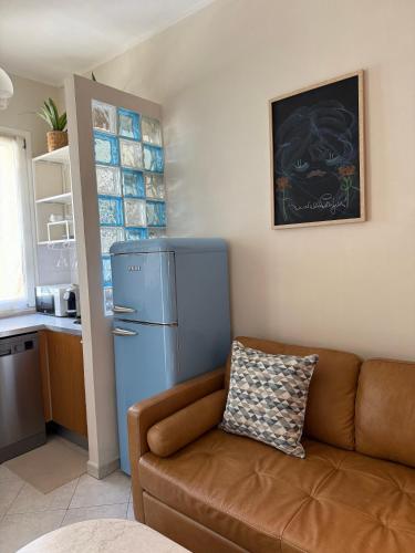 a living room with a couch and a refrigerator at Robert HoME Deluxe Apartment Turin in Turin