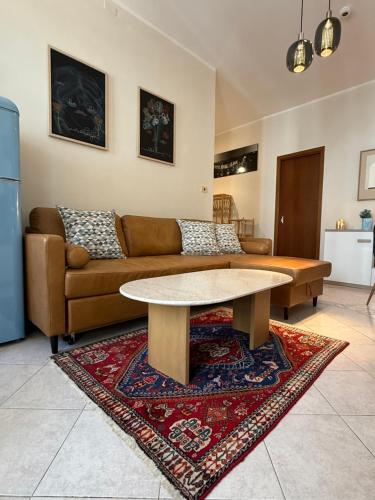 a living room with a couch and a table at Robert HoME Deluxe Apartment Turin in Turin